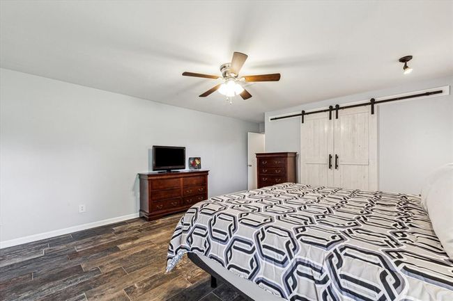 The closet barn doors in the primary bedroom carry the character and charm throughout this home | Image 24