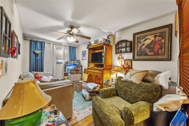 Living room featuring a ceiling fan and wood finished floors | Image 28