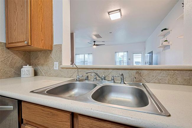 View from the kitchen sink into main living space. Whole house has a Culligan water treatment system! | Image 15