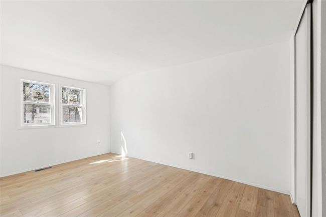 Empty room featuring visible vents and light wood-type flooring | Image 7