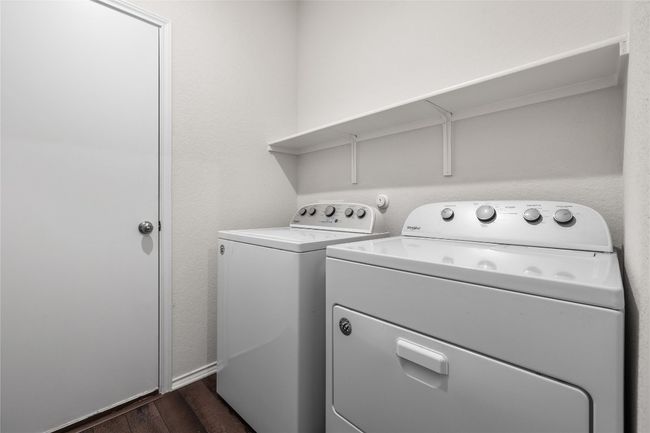 Washroom with laminate wood-type flooring (washing machine and dryer will be removed) | Image 28