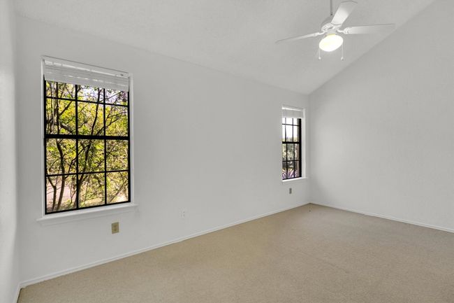 Spare room featuring baseboards, vaulted ceiling, ceiling fan, and carpet floors | Image 21