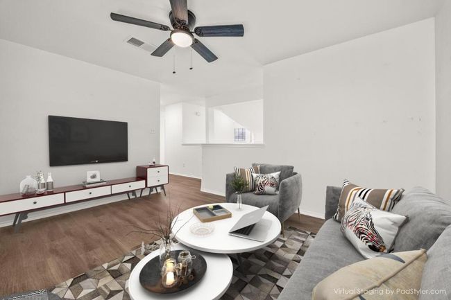 Virtually staged Upstairs Living room with baseboards, visible vents, wood finished floors, and ceiling fan | Image 17