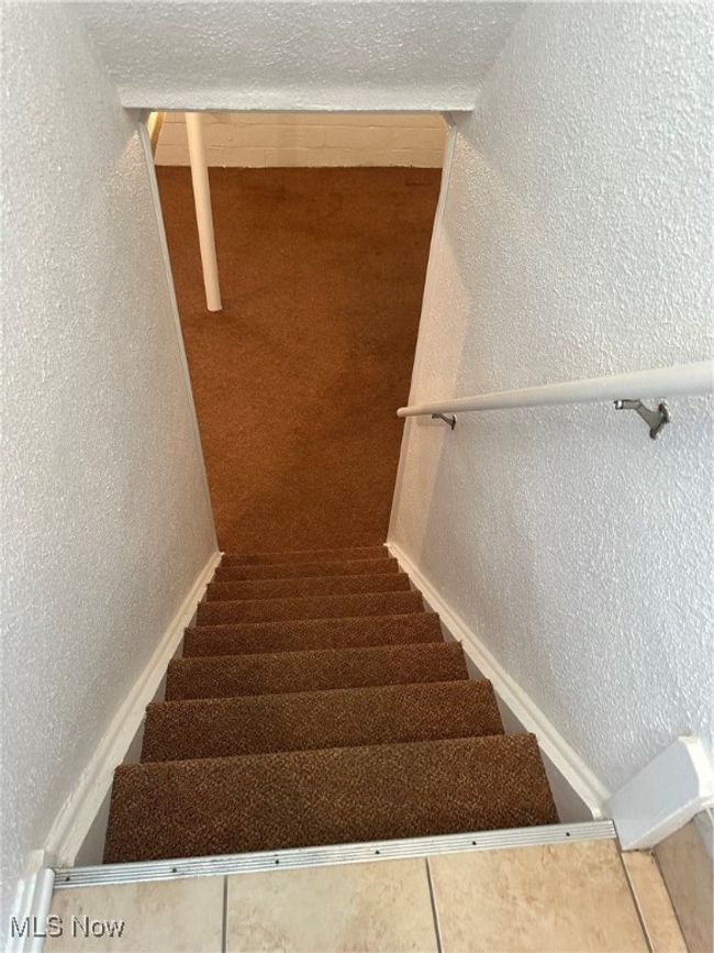 Stairs featuring baseboards and a textured wall | Image 31