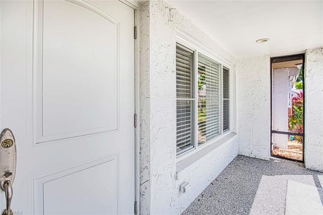 Doorway to property with stucco siding | Image 9