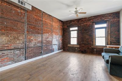 Exposed brick and original hardwood floors | Image 3