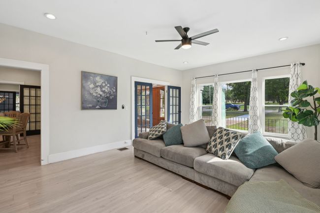 Living area with baseboards, light wood finished floors, ceiling fan, and recessed lighting | Image 8