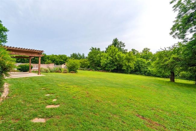 Fenced backyard with a patio area and a pergola | Image 41