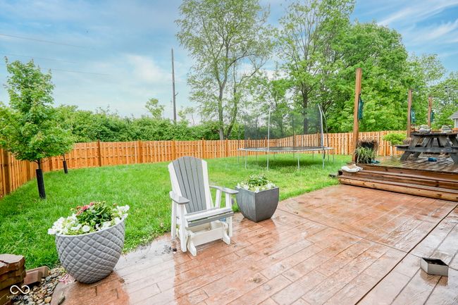 wooden terrace with a trampoline | Image 6