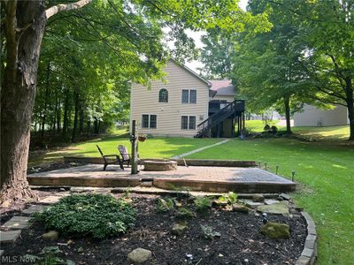 View of yard featuring a patio and a wooden deck | Image 2