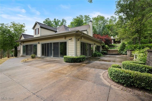 View of home's exterior with a patio and a chimney | Image 4