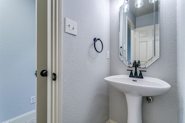 Bathroom with a textured wall | Image 7