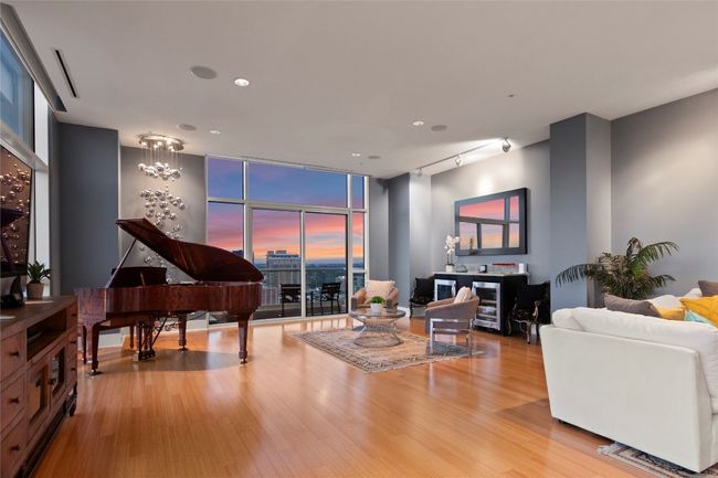 The piano positioned to offer a stunning view of the cityscape, making it a perfect spot for playing music while enjoying the scenic surroundings | Image 6