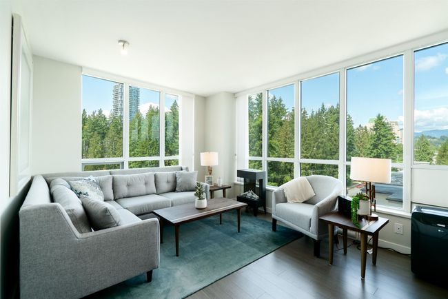 Living area with healthy amount of natural light and wood finished floors | Image 10