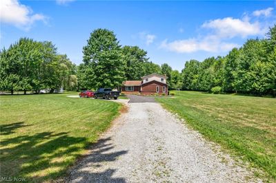 View of front of home with a garage and a front yard | Image 1