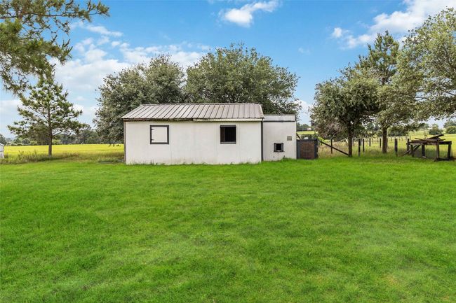 View of yard featuring an outbuilding and a pole building | Image 27