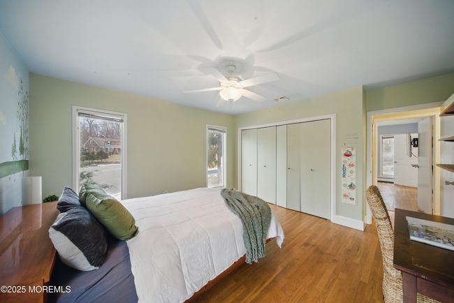 bedroom #2 with painted lake mural , large windows & custom closets. | Image 26