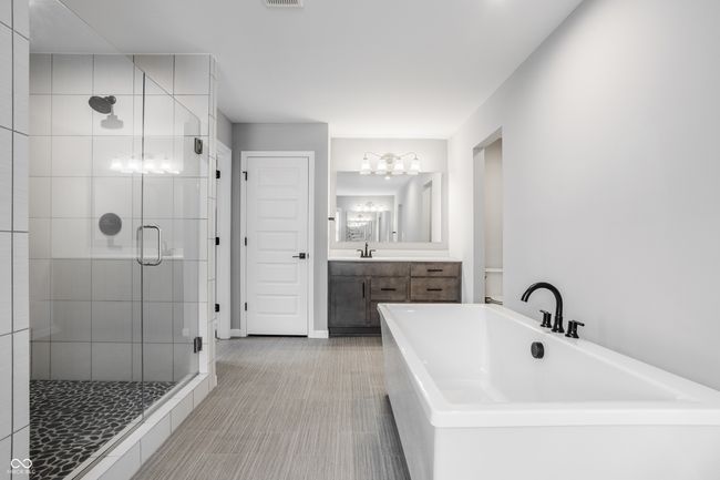 Primary bathroom with large soaking tub and shower with dual shower heads. | Image 36