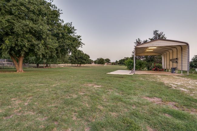 View of grassy yard featuring a carport | Image 24