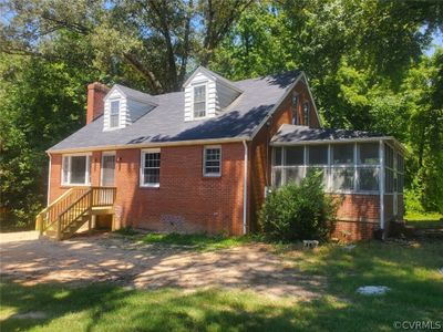 View of property exterior with a sunroom | Image 1