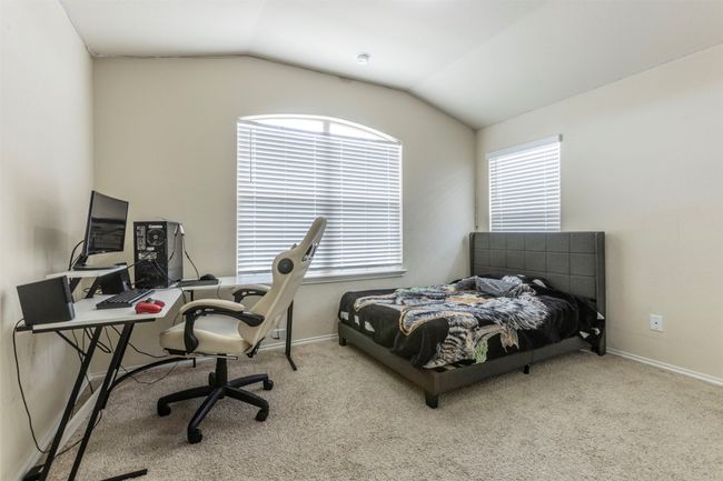 Bedroom featuring vaulted ceiling, multiple windows, and carpet | Image 24