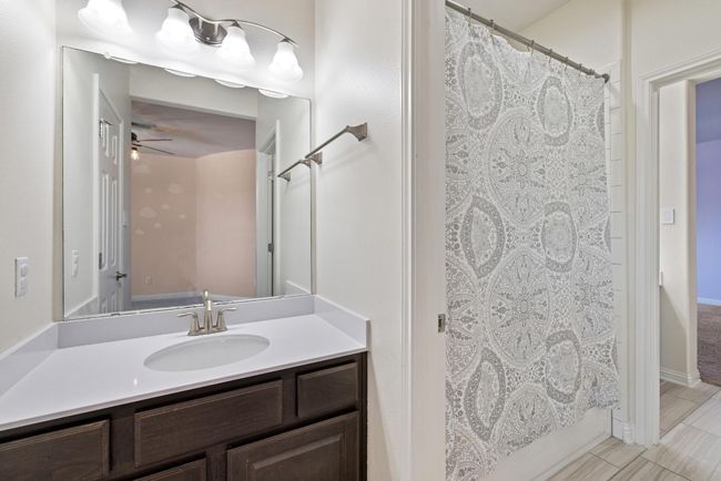 Full bathroom with vanity, ceiling fan, and a shower with curtain | Image 32