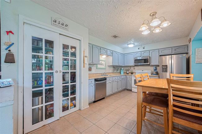 The kitchen offers plenty of counter and cabinet space that seamlessly combines practicality. | Image 9