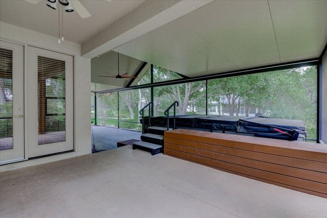 Sunroom / solarium featuring a swim/spa, french doors, healthy amount of natural light, and lofted ceiling | Image 35