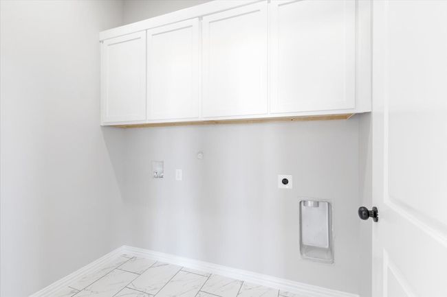 Laundry room with electric dryer hookup, light marble finish floors, cabinet space, washer hookup, and hookup for a gas dryer | Image 18