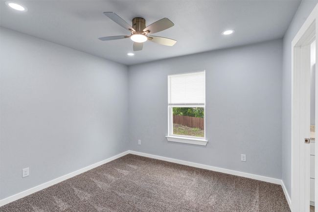 Empty room featuring dark carpet, a ceiling fan, and recessed lighting | Image 35