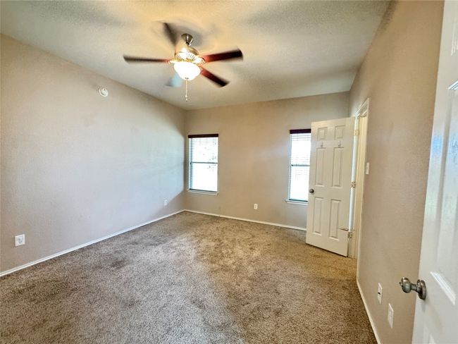 Spare room with carpet, ceiling fan, and a textured ceiling | Image 12