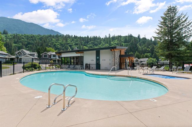 Pool with a forest view, a mountain view, a patio, and fence | Image 34