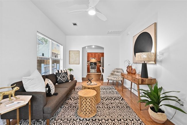 living room flows easily into kitchen. | Image 8