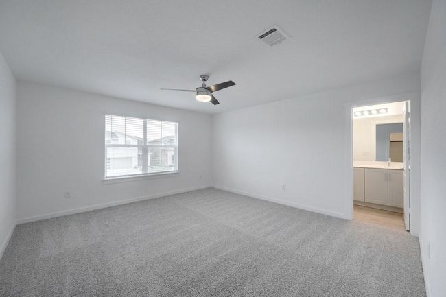 Empty room with light colored carpet and ceiling fan | Image 4