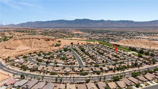 Aerial overview of property's location with a mountainous background and nearby suburban area | Image 51
