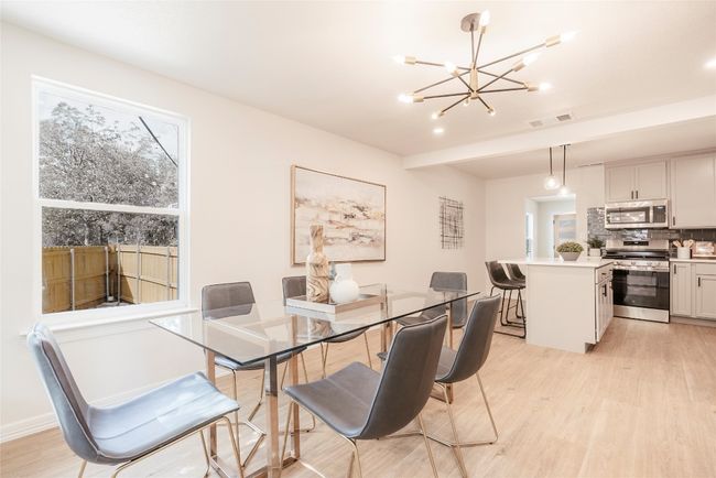 Dining room featuring light wood-type flooring and a chandelier | Image 13