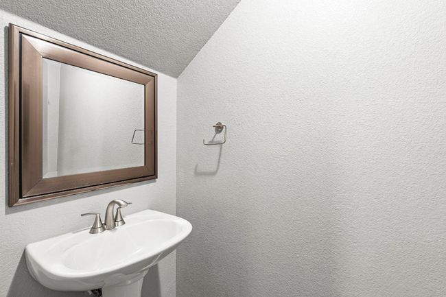 Bathroom with a textured wall | Image 7