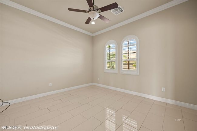 Unfurnished room featuring visible vents, baseboards, light tile patterned floors, ornamental molding, and a ceiling fan | Image 8