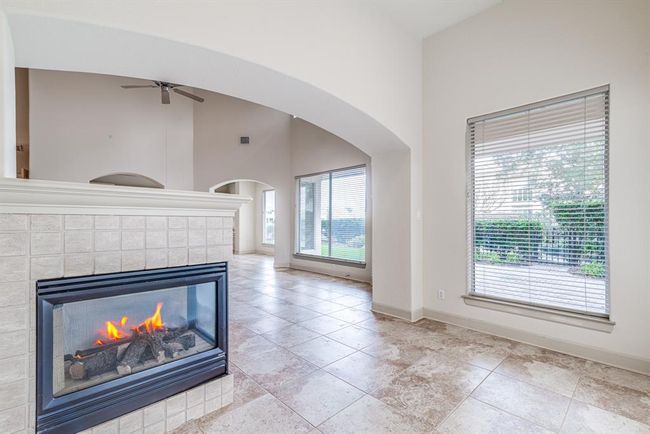 Additional living space with cozy double sided gas log fireplace. | Image 22