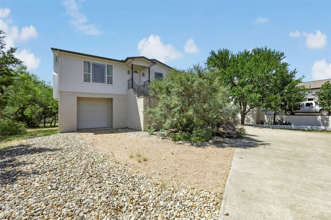 View of front facade with driveway, a garage, and stairway | Image 35