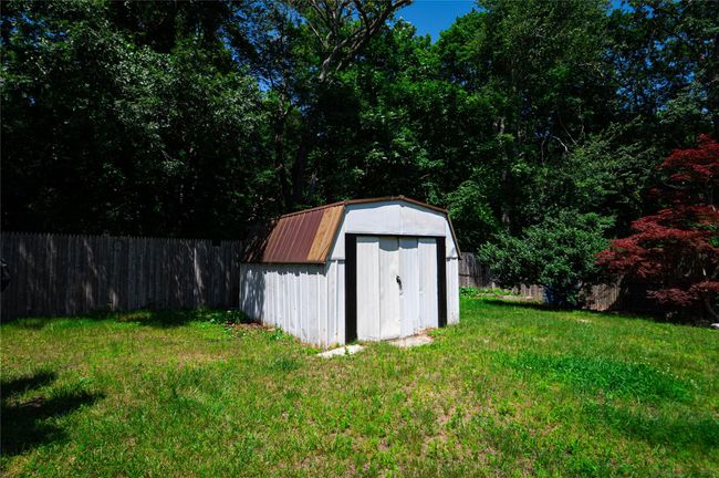 View of shed with a fenced backyard | Image 14