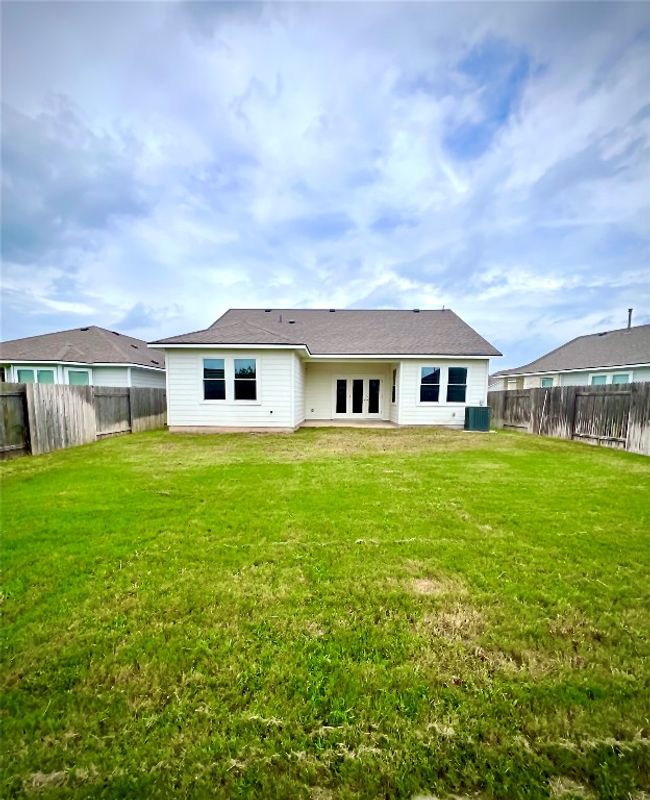 Back of property with a large fenced backyard. | Image 18