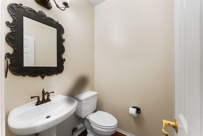 Bathroom with baseboards, a sink, and toilet | Image 23