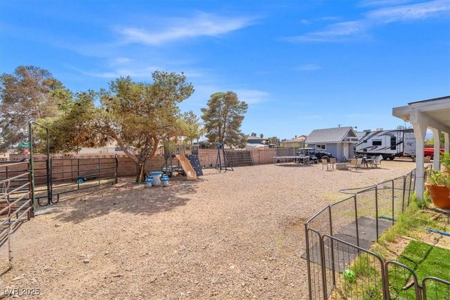 View of yard featuring fence and a playground | Image 26