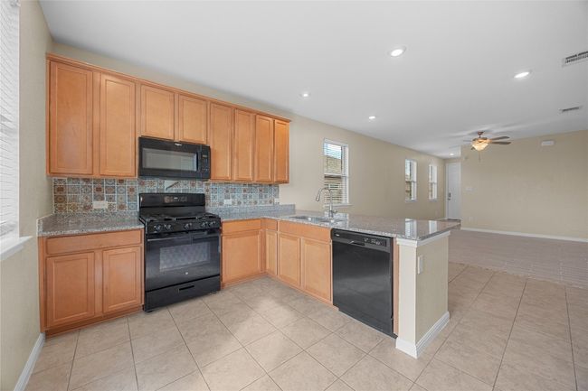 Built-in mircro-hood and a gas range, recessed lighting | Image 9