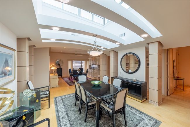 Dining room with skylights, arched ceiling, and light wood flooring | Image 4