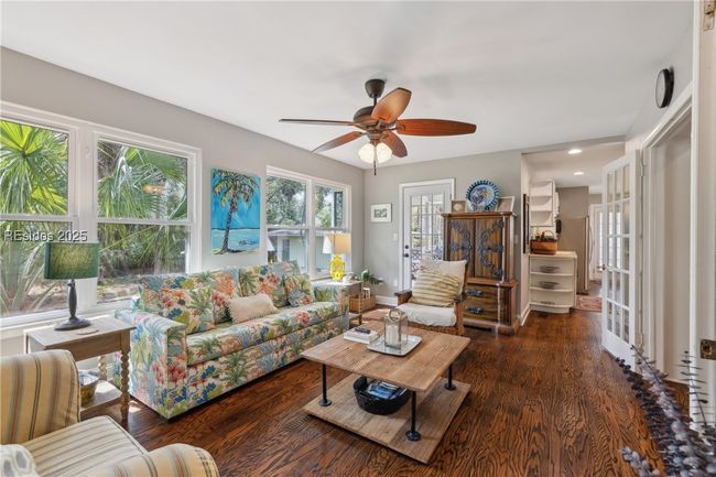 Second living room with plenty of lounging areas, gorgeous open windows allow for plenty of natural light if desired, hardwood floors. | Image 38