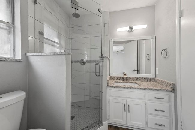 Bathroom with toilet, walk in shower, and vanity | Image 15