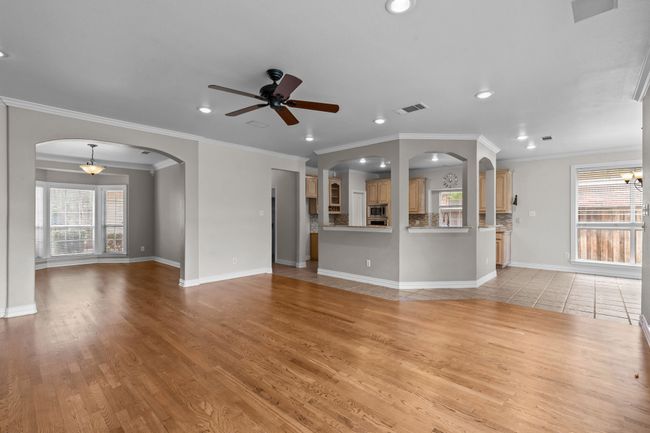 Oversized family room with traditional fire place and a wall of windows overlooking backyard | Image 10