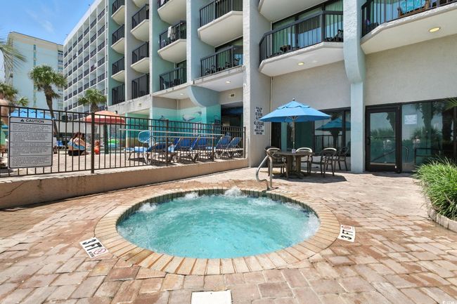 View of swimming pool featuring a hot tub, a pool, and a patio area | Image 36